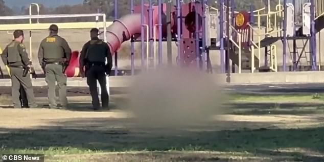 After seriously wounding two boys aged five and six at the small religious school on Wednesday, the gunman then turned the gun on himself. In the photo: the police stand by his body