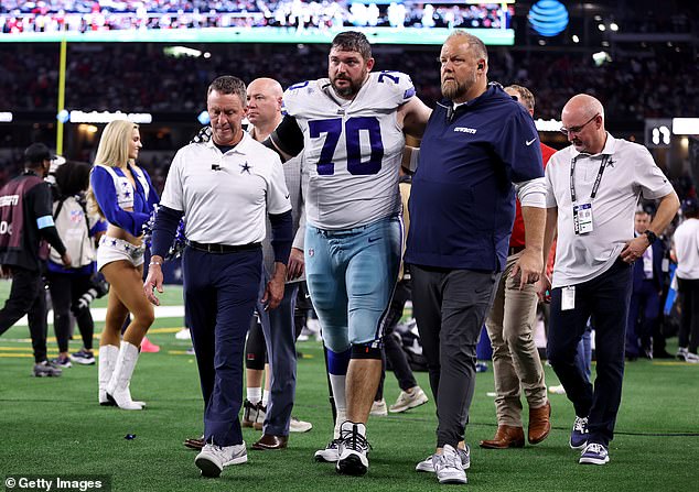 Martin receives assistance off the field after being injured against the Houston Texans on November 18