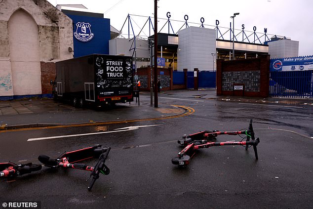 Electric scooters are scattered on the sidewalk outside Goodison Park, where Liverpool were due to play Everton on Saturday.