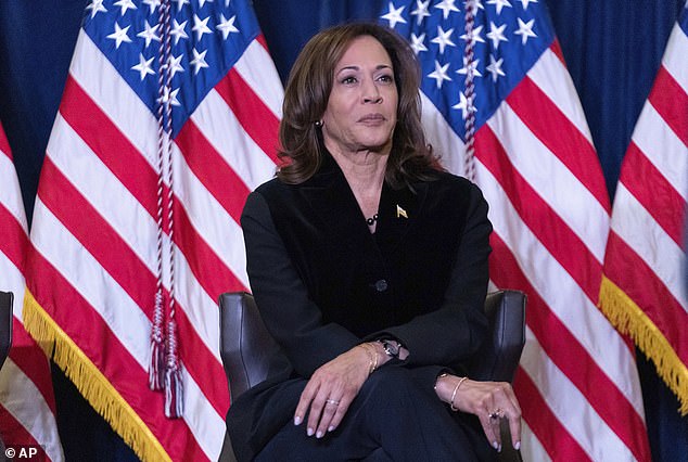 Vice President Kamala Harris listens as First Lady Jill Biden speaks at the Democratic National Committee Christmas Reception