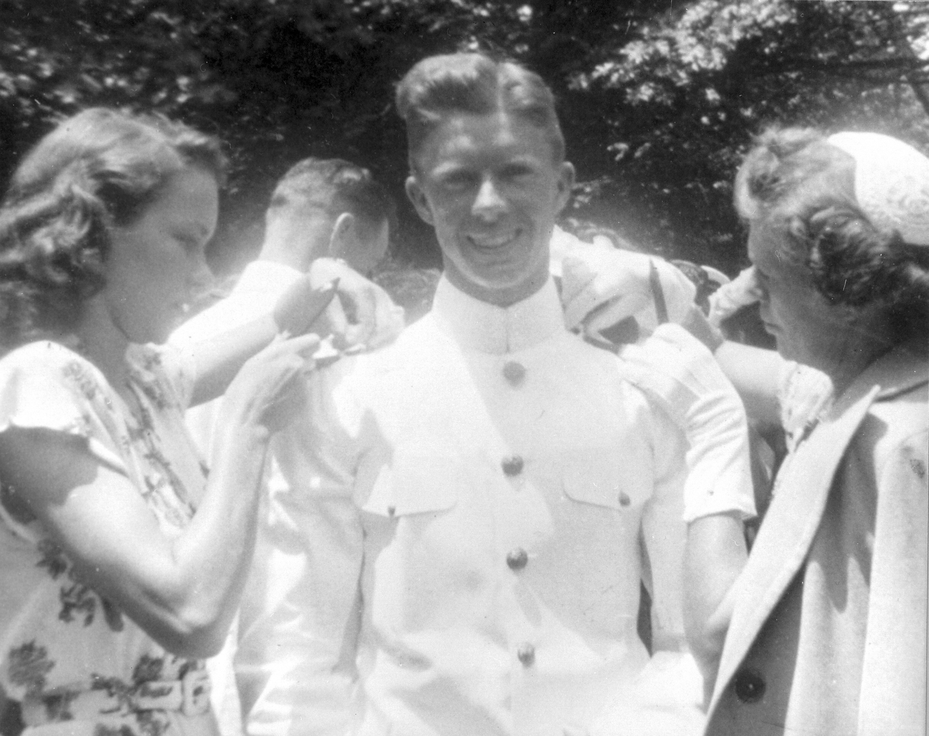 Rosalynn Carter (left) and Lillian Carter pin insignia bars on new Naval Academy graduate Jimmy Carter in 1946.