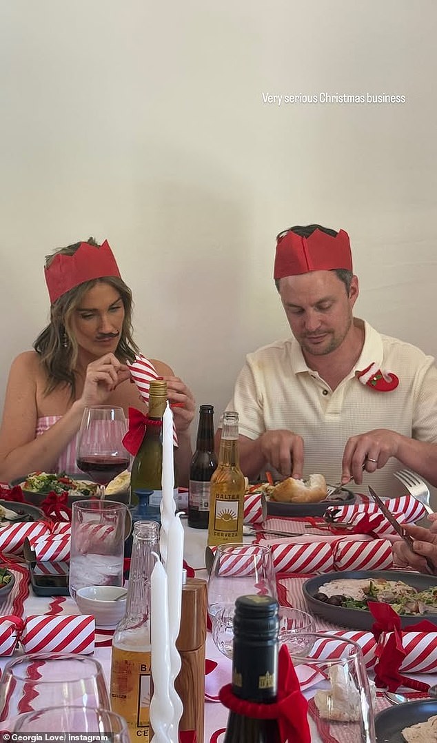 In one photo, Georgia was sitting next to a man wearing a ring on his finger, perhaps a married friend, while she was busy fiddling with a toy found inside a Christmas candy.