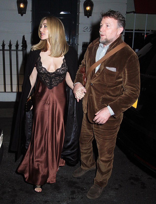 Guy held his beloved wife's hand as they left the restaurant after a relaxing evening together.