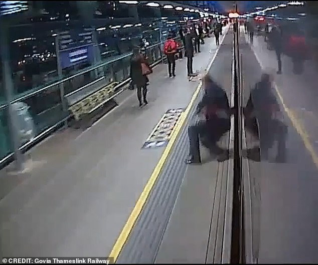 Instead, the train appears to clip his feet, causing the man to spin around before fellow passengers can be seen running to help the man before the clip ends abruptly.