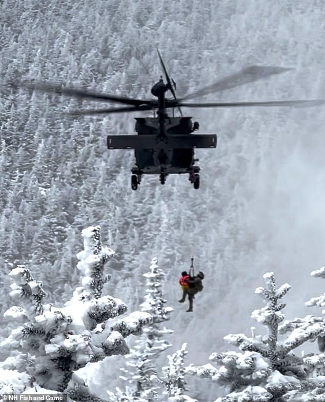 Sergeant 1st Class Ethan Major, a flight medic with the New Hampshire Army National Guard, and stricken hiker Patrick Bittman are lifted into a Black Hawk helicopter during a successful search and rescue mission on Franconia Ridge, New Hampshire