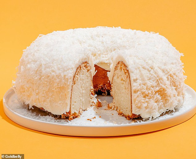 According to Goldbelly, the cake consists of a ring of luxurious, moist coconut Bundt cake, pieces of sweet white chocolate, a layer of cream cheese frosting, and coconut flakes on top.