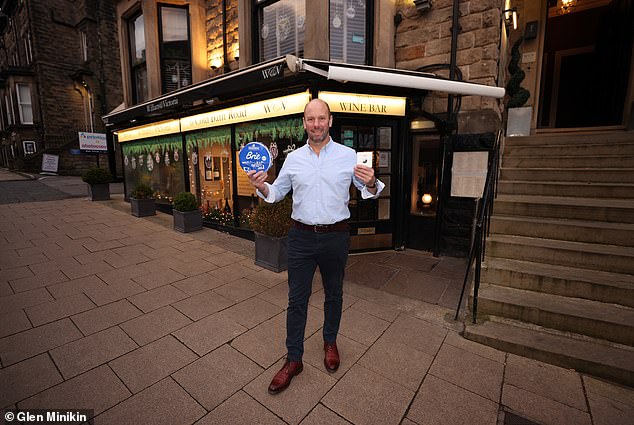 David Straker poses with his cheese. It has issued the following warning: 'Next time you see a suspicious cyclist with a backpack full of dairy, think of us and our lost Brie. And remember: crime may pay, but cheese always costs