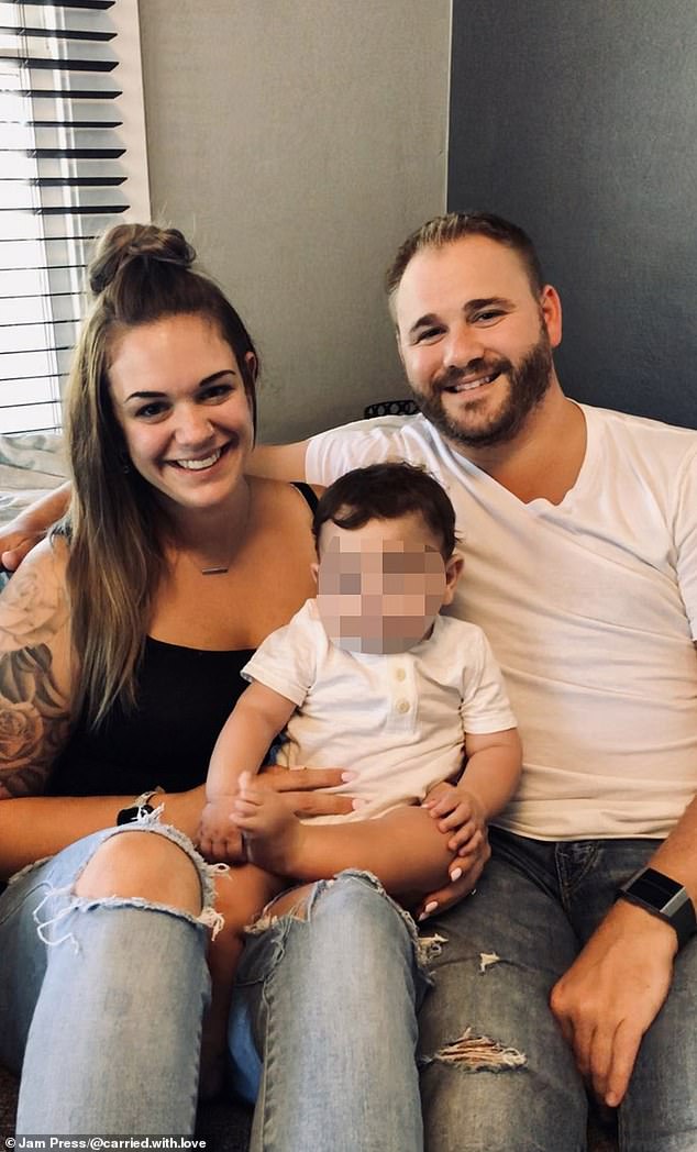 Ms Taylor is pictured with her partner Brandon (right) and a baby she gave birth to. She said Brandon is very supportive of her journey and agrees that surrogacy is a great act of service.