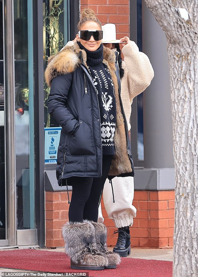 The Let's Get Loud hitmaker, 55, showed off her chic style in a black fur-lined parka and printed turtleneck.