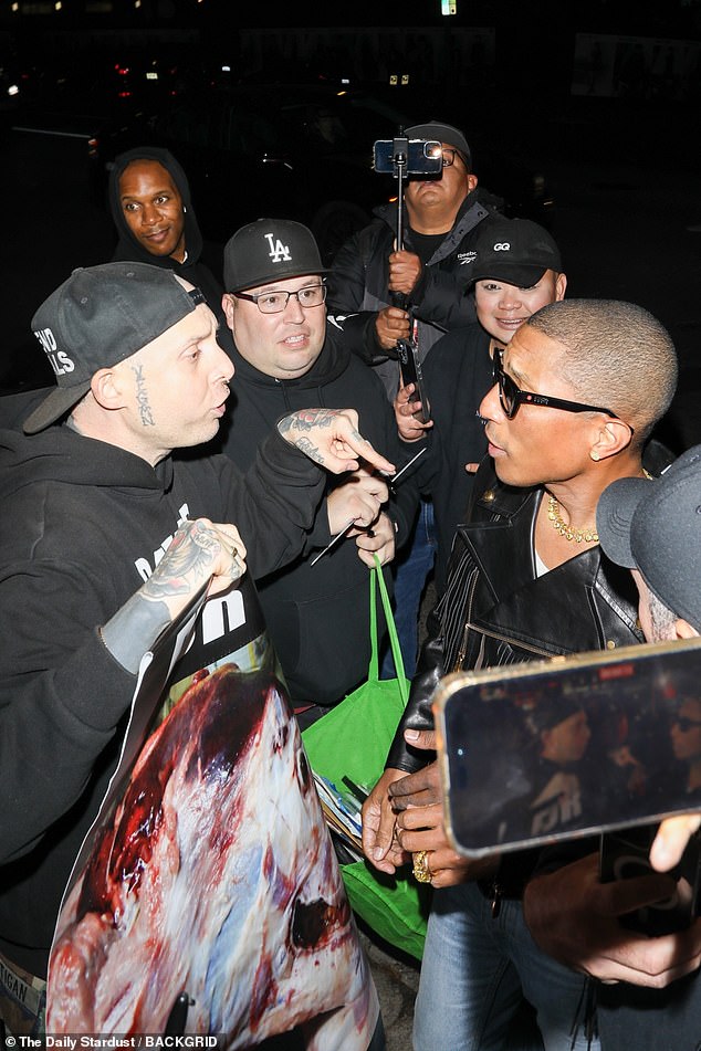 Pharrell attempted to hug an animal rights activist who confronted him outside the Chateau Marmont after the GQ Men of the Year Awards in November.