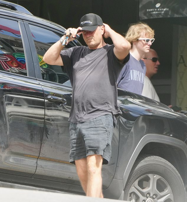 Keeping things low-key, Karl cut a relaxed figure in a black T-shirt and shorts, which he paired with a dark baseball cap.