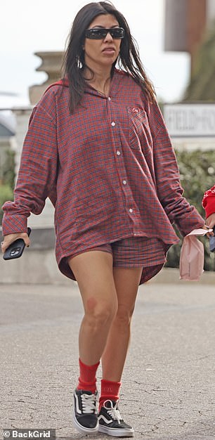 Kourtney wore her dark hair down over silky drapes.