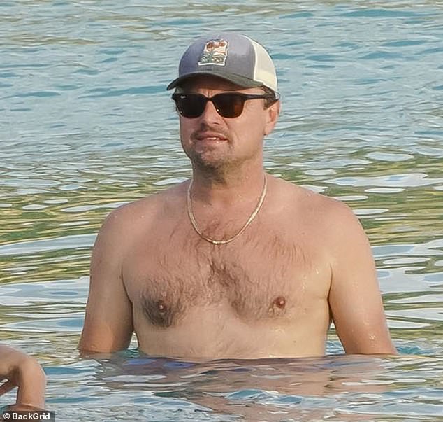 The Oscar winner, 50, went shirtless for a dip in the ocean