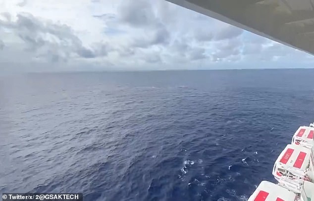 Passengers were seen looking out into the open ocean as the search for the missing guest continued