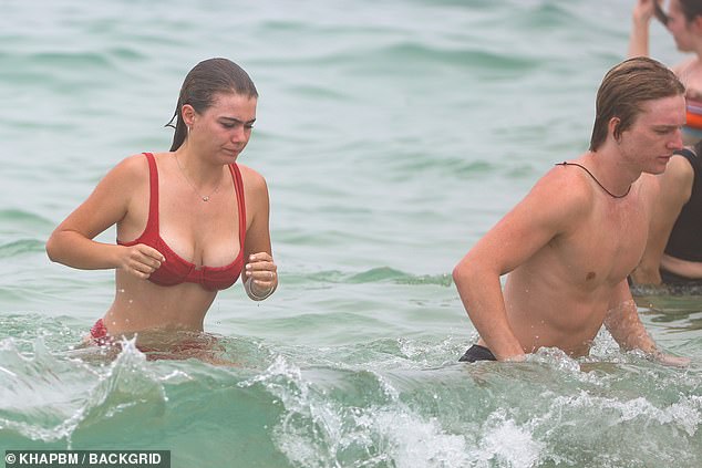 She and her boyfriend took a quick dip before heading back to the sand to lounge on their beach towels.