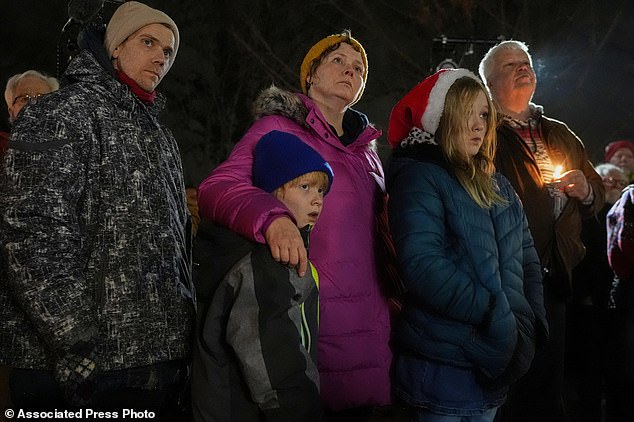 Supporters hold candles during a candlelight vigil Tuesday outside the Wisconsin Capitol in Madison