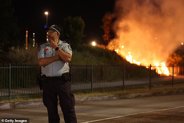 NSW Police clear the scene of the fire at Leagues Club Park in Gosford (pictured)