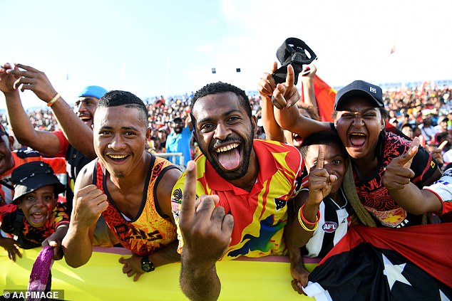 Rugby league is the national sport of Papua New Guinea (pictured, fans watch the Kumuls in action in Port Moresby) - an NRL team is expected to be operational in 2028.