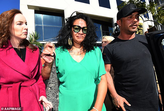 Haas's mother, Joan Taufua (pictured, center), is behind bars awaiting trial after three people died in a car crash involving a vehicle she was driving in 2022.