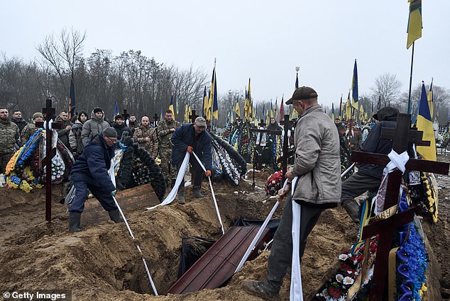 Mourners attend the funeral of a Ukrainian soldier on November 30, 2024 in Kiev, Ukraine