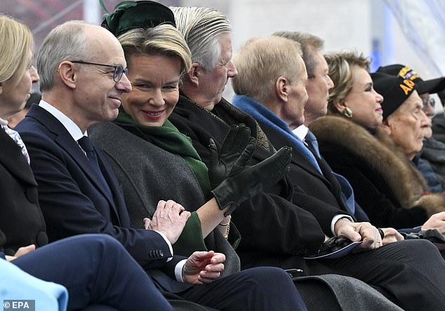 Queen Mathilde of Belgium (pictured, center) speaks with Luxembourg Prime Minister Luc Frieden (pictured, left).