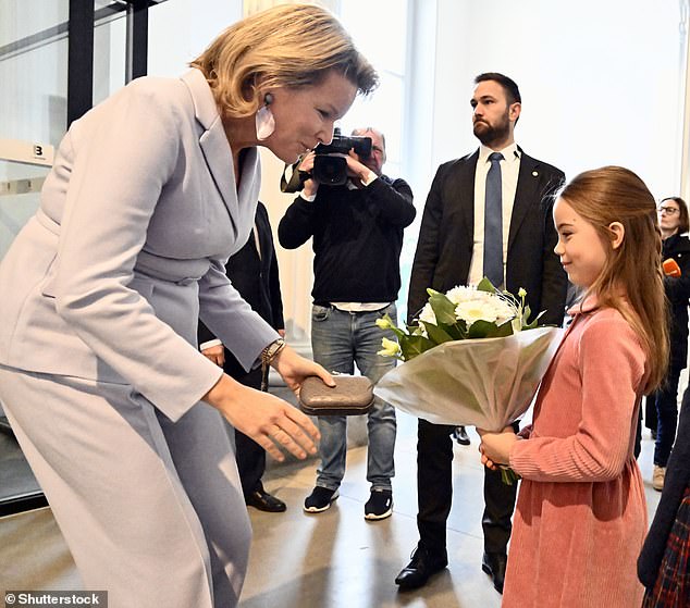 During the visit, the mother of four children shared a sweet moment with a little girl after she gave the queen a bouquet of white flowers.