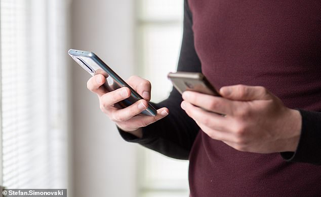 Carrying two mobile phones, an increasingly common behavior, could reveal a lot about your personality, according to psychologists (file photo)