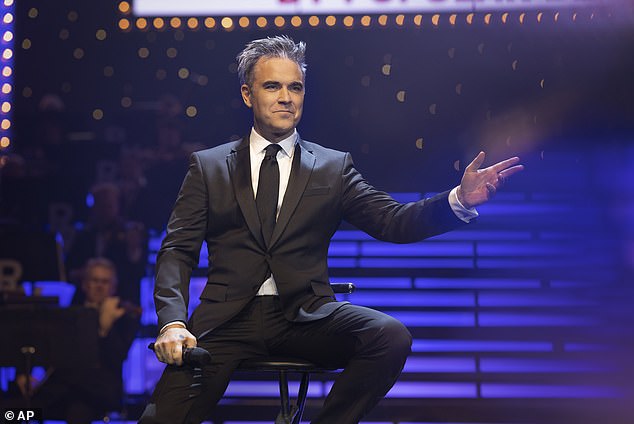 The semi-biographical film follows the singer's meteoric rise to fame as a member of Take That and his subsequent dramatic fall, as he struggled with his personal demons and the challenges that success can bring (pictured in the film).