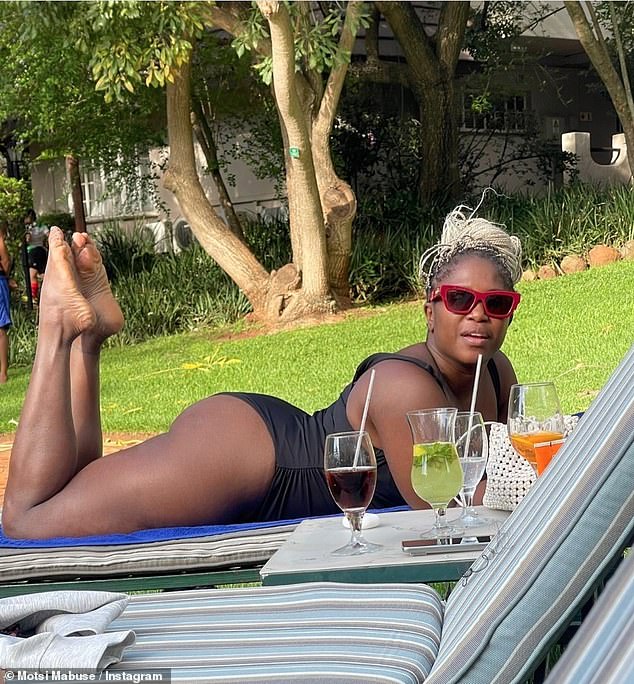 The Strictly judge, 43, showed off her sculpted derriere as she relaxed on a sun lounger in South Africa wearing a pair of stylish red-framed sunglasses.