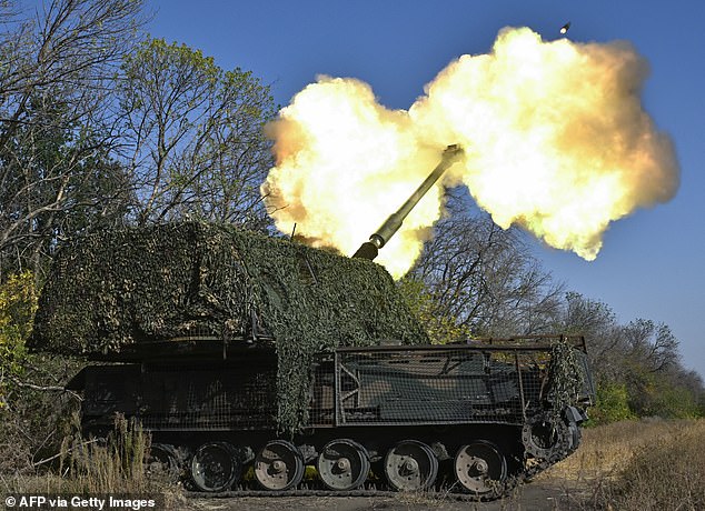 Ukrainian soldiers fire a howitzer at Russian positions near the front line in Khasiv Yar, Donetsk