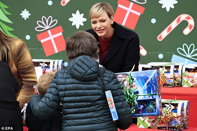 Charlene chats with the families who visited the palace for the gift-giving event last year.