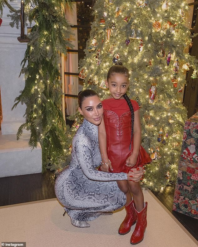 She posed up a storm next to the Christmas tree, as well as bending down to hug her youngest daughter, six-year-old Chicago.