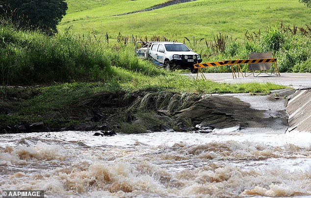 The material, which was detected at the Mount Crosby water treatment plant, formed due to heavy rain and hot weather conditions in parts of the state (pictured, a flooded road in Queensland).