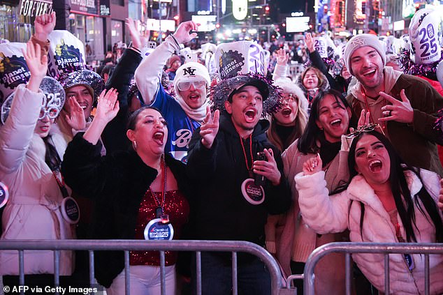 Revelers were seen between the barricades donning their New Year's attire, including glittery hats and waterproof ponchos.