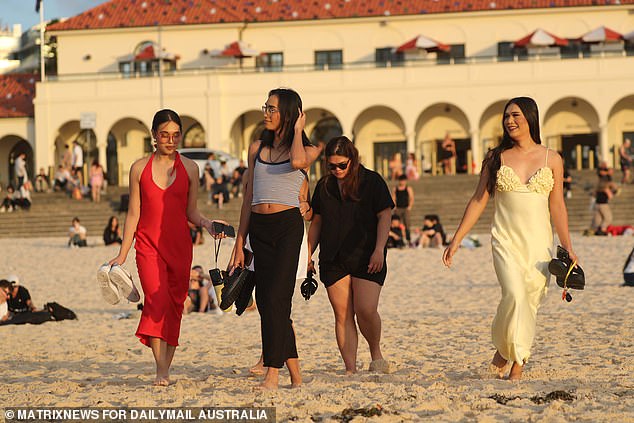 As fitness fanatics finished their morning runs, revelers, still dressed to the nines, strolled the sand.