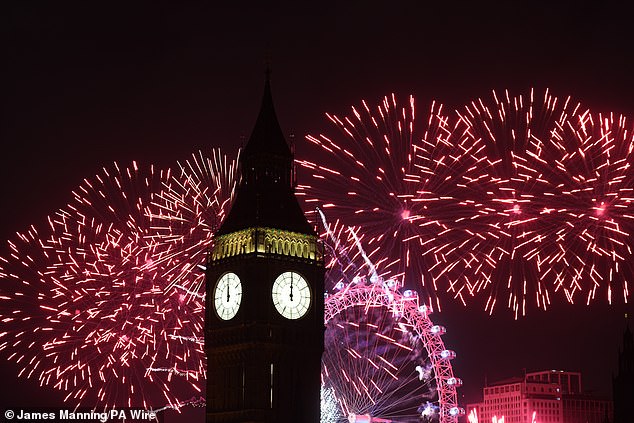 Fireworks light up the sky over the Elizabeth Tower, also known as Big Ben, and the London Eye in central London during New Year celebrations.