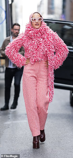 For her second look, the beauty made a statement wearing a pair of pink tweed pants and a pink and white sweater.