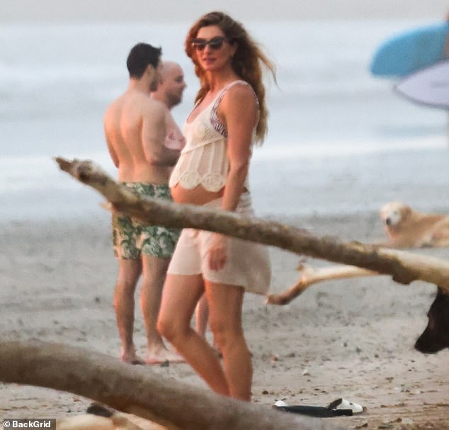 The Vogue model, 44, wore a tiny beige crochet top that was so short it revealed part of her bare tummy.