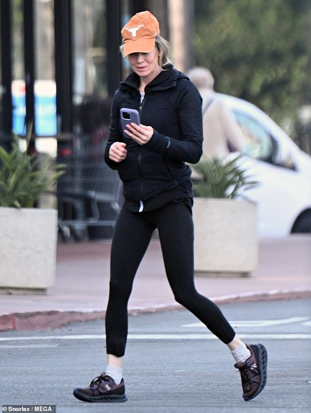 The Oscar winner stepped out in a black jacket and matching leggings with black and blue sneakers. He placed an orange billed cap with the Texas Longhorns logo over his blonde locks.