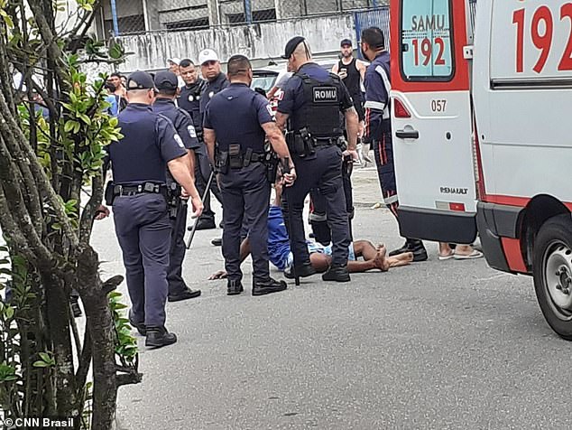 Claudio da Silva is surrounded by police in Praia Grande, a coastal town in the southeastern Brazilian city of São Paulo, on Sunday, moments after he allegedly stole a man's cell phone, starting a wild chase captured by a camera that showed how he was hit from behind. a van driven by the friend of the robbery victim, who also ran over and killed a mother and her daughter