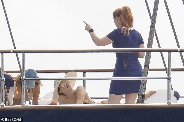 In one photo, Lauren was seen sunbathing in her daring swimsuit as she spoke to a woman who appeared to be one of the officials with a walkie-talkie in her back pocket