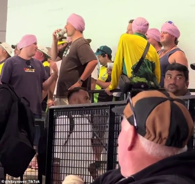 A video showing Australian fans wearing the helmet at the match (pictured) has received praise for showing a softer side of cricket's rivalry with India.