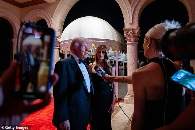 President-elect Donald Trump (left) and Melania Trump (right) walk the red carpet on Tuesday ahead of their New Year's Eve party at Mar-a-Lago