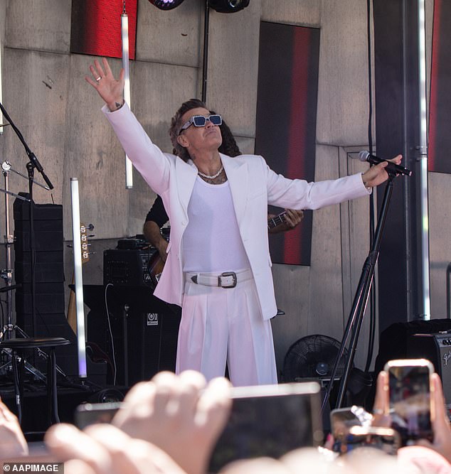 The award-winning hitmaker opened the show with his 1997 smash hit Let Me Entertain You while stepping out in a crisp white jacket and dazzling sunglasses.