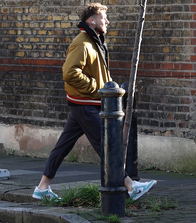 While he was out, he was dressed casually in a beige jacket, sweatpants and had headphones on.