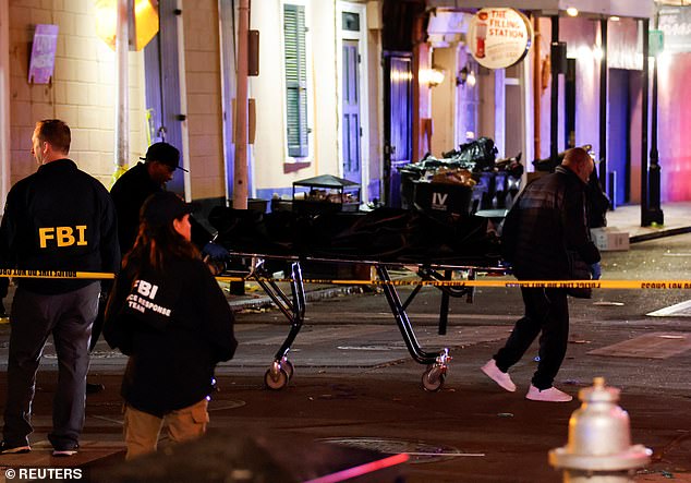 People carry a corpse in a body bag on a stretcher near the site where people were killed by a man driving a truck during an attack during New Year's celebrations in New Orleans