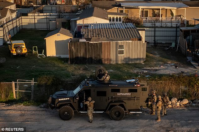 A drone view shows Federal Bureau of Investigation (FBI) and Harris County law enforcement officials surrounding a residence in an armored vehicle in north Houston, Texas, US, on January 1, 2025.