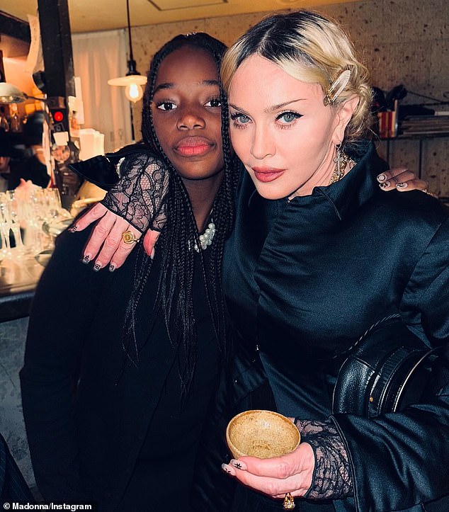 In another image, Madonna posed with one of her adopted identical twin daughters, Stella and Estere, 12.