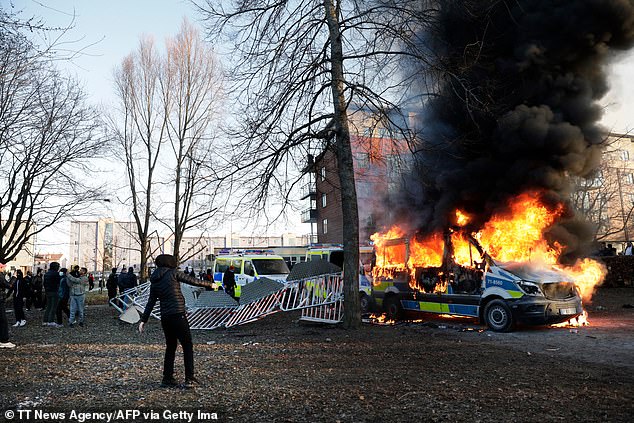 Police vans burn amid clashes between protesters and police in 2022