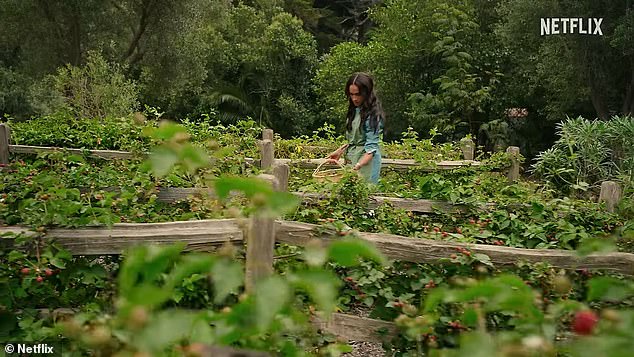 In one scene, Meghan walks through her garden and picks fresh fruit, while wearing a denim jumpsuit.